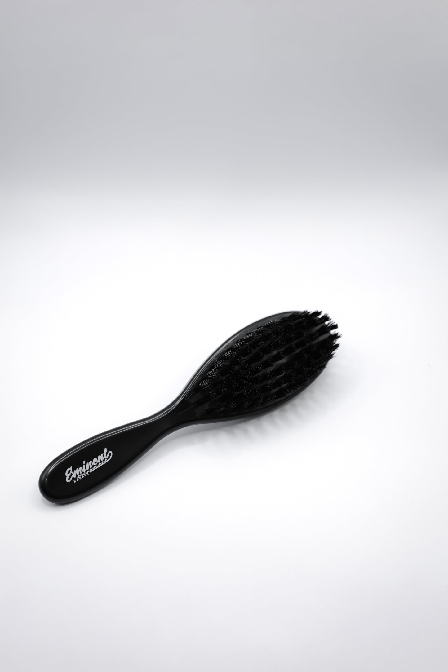 Black hairbrush on a white background
